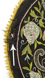 Antique embroidered parrot on perch.